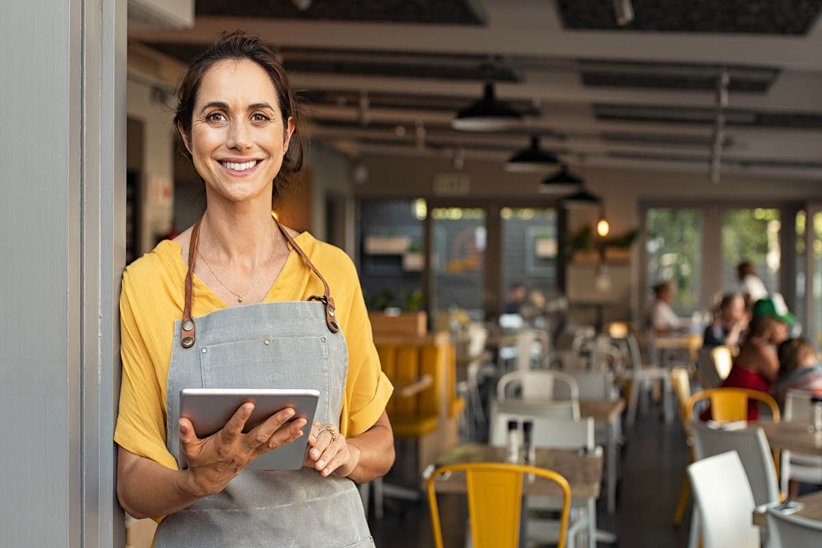 Business owner standing outside cafe