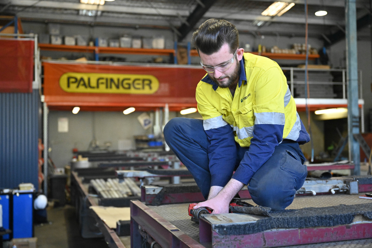 man drilling in industrial workshop