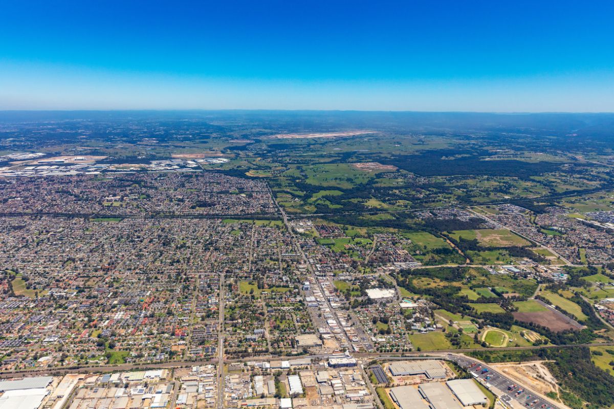 aerial view of roads and buildings with the horizon in the distance