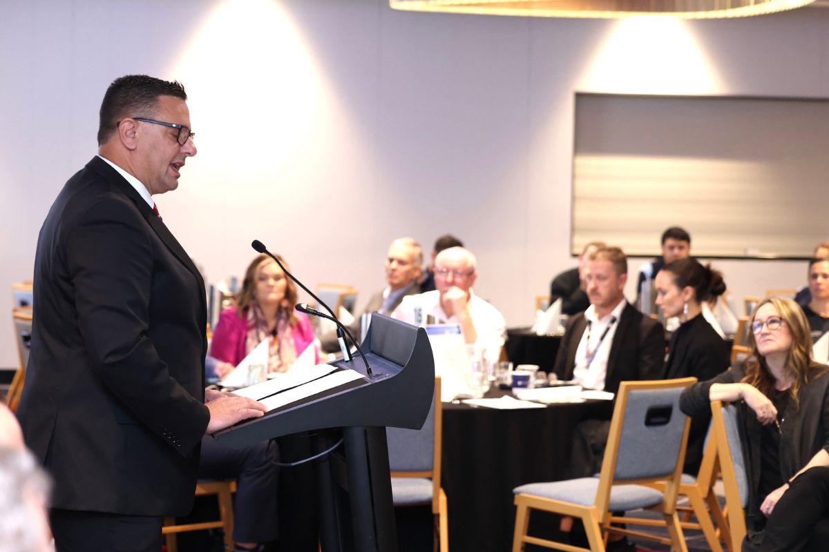 man speaking at lectern