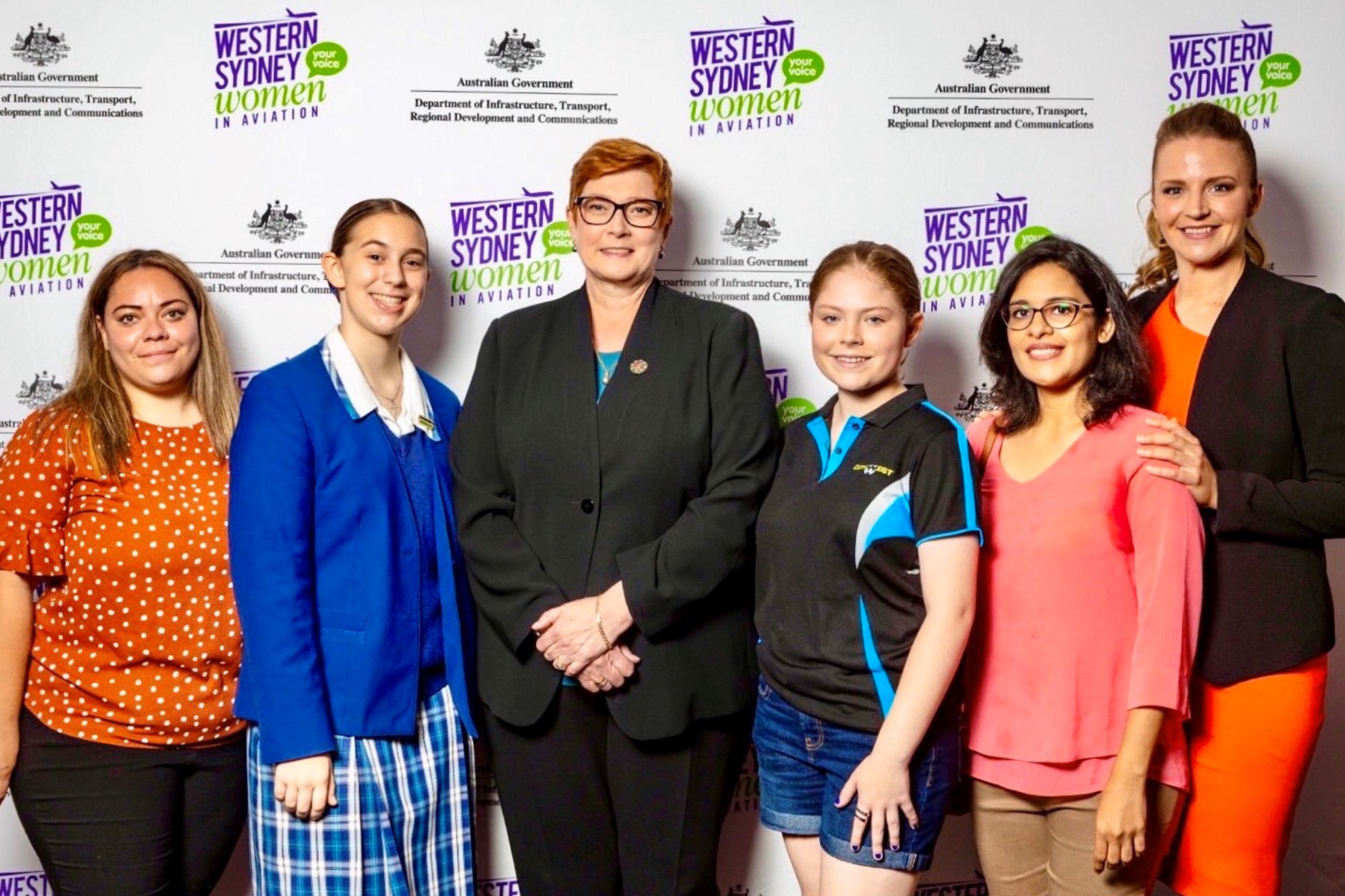 six women including senator marise payne smiling at camera