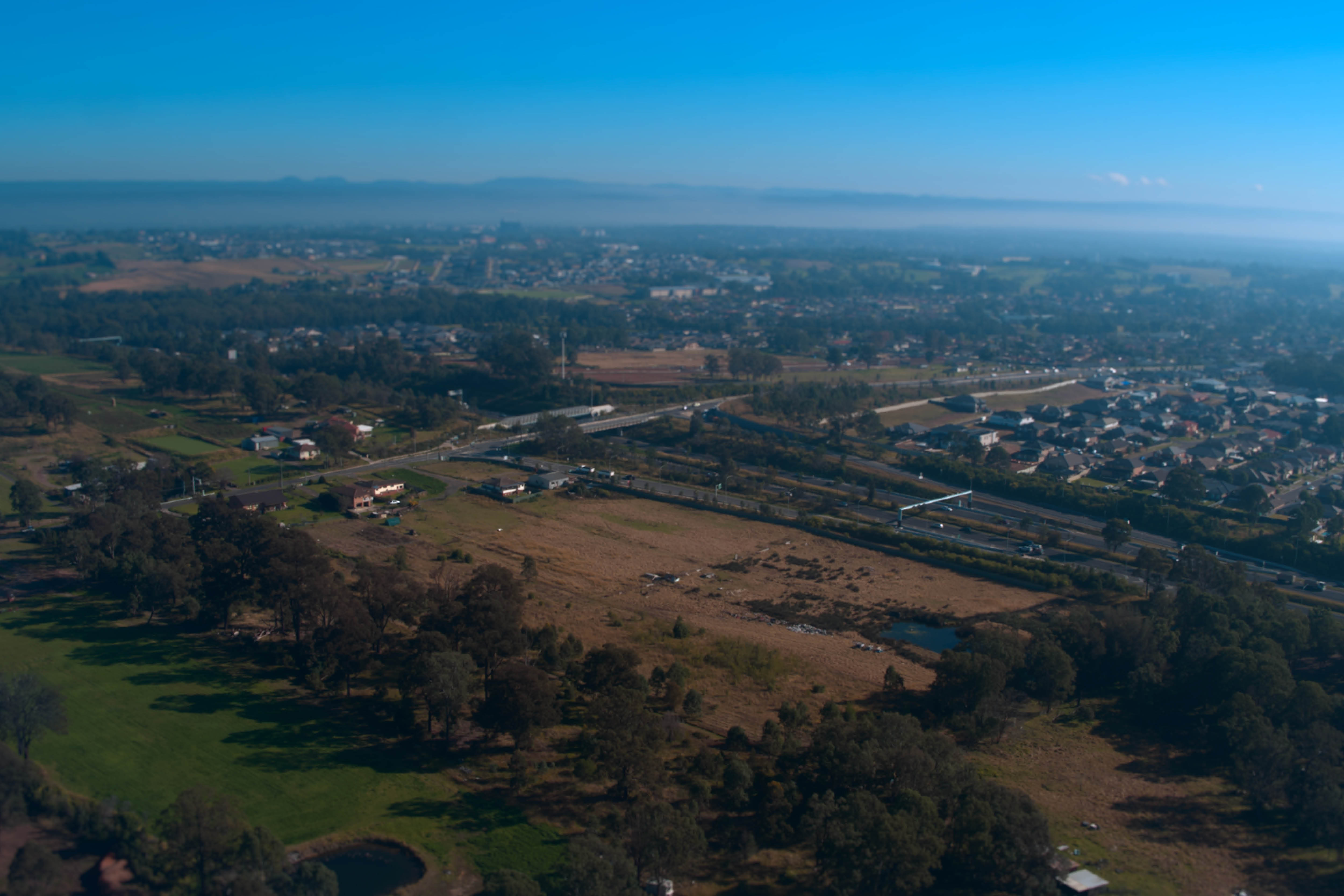 aerial image of roads, houses and green space