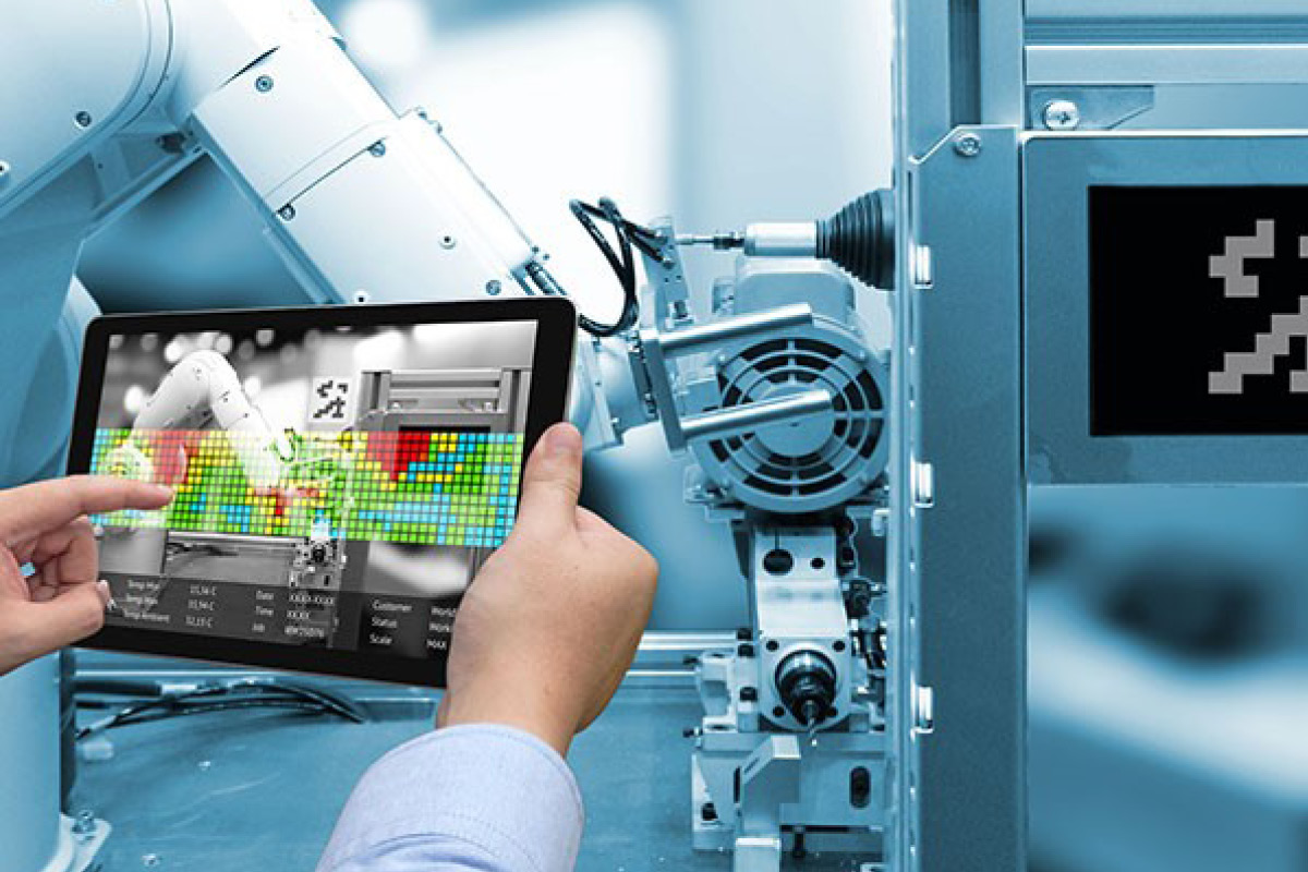 Hands holding a table showing manufacturing software