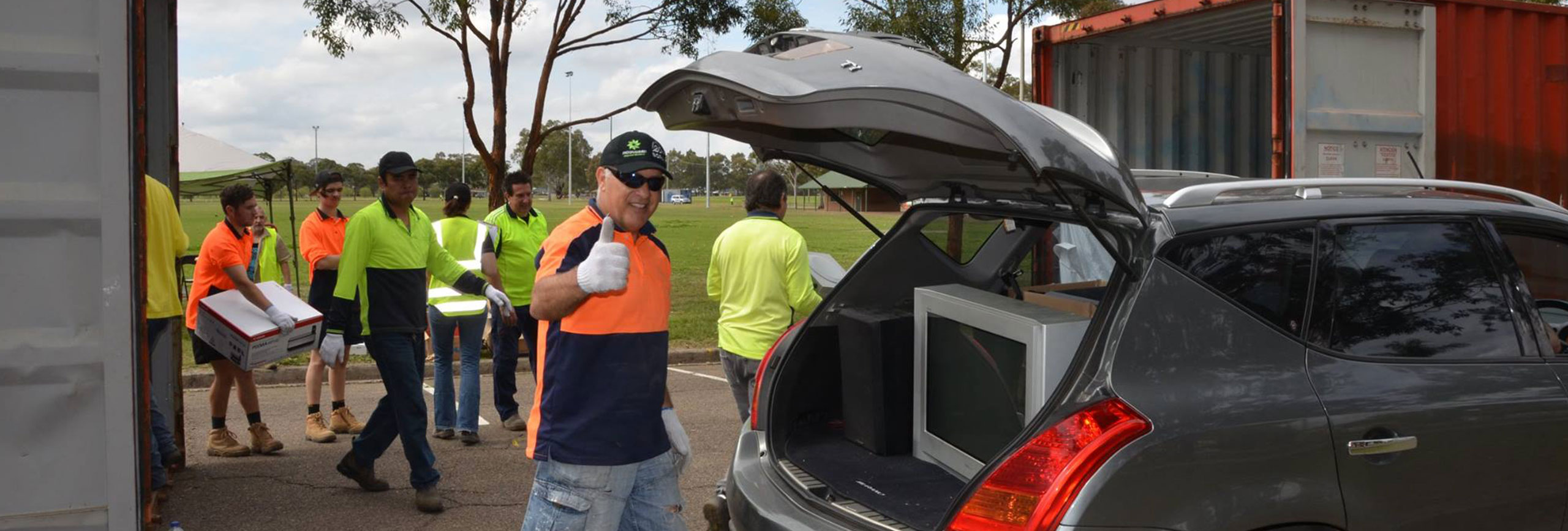 Photo of Council worker unloading electronic waste and giving a thumbs up